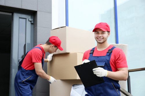 Local moving team handling boxes and furniture in Enfieldhighway