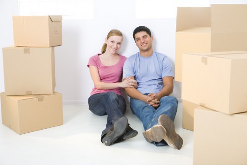 Removalists carrying furniture through a narrow hallway