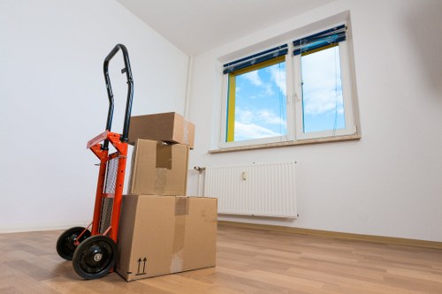 Moving team handling boxes and furniture on a local Enfieldhighway street